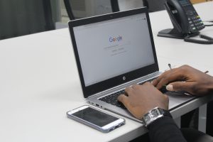 Person using laptop with Google on the screen