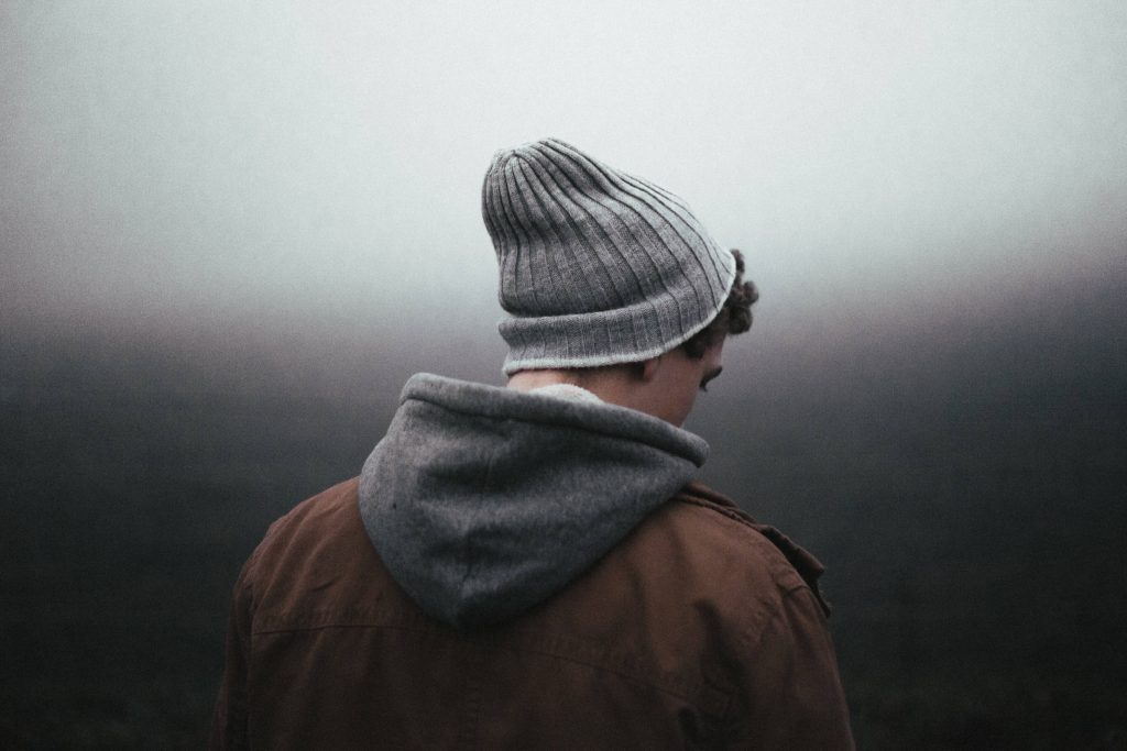 Man looking concerned in front of grey skyline